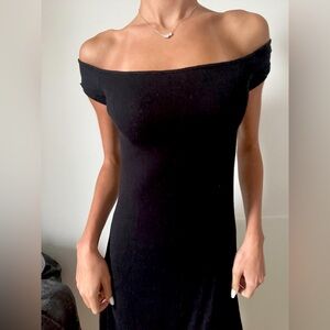 Simple black dress. Just above the knee. Very stretchy and soft material.